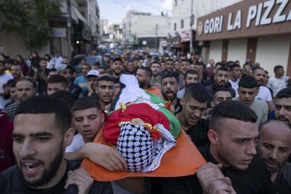 Mourners carry the body of Ayham Shafe